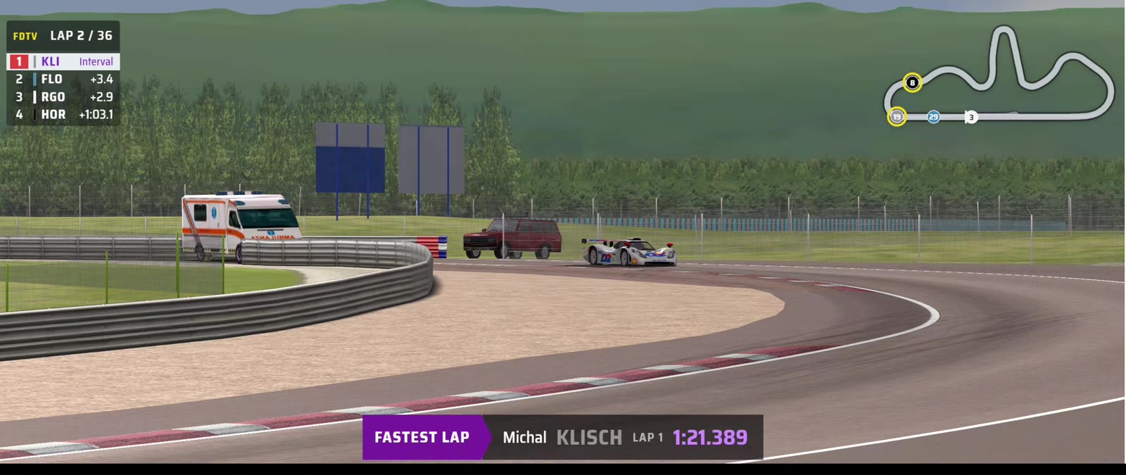 Dijon, lap 2 of 36: modern tower with Klisch leading, and the purple fastest lap card for Michal Klisch, lap 1, 1:21.389